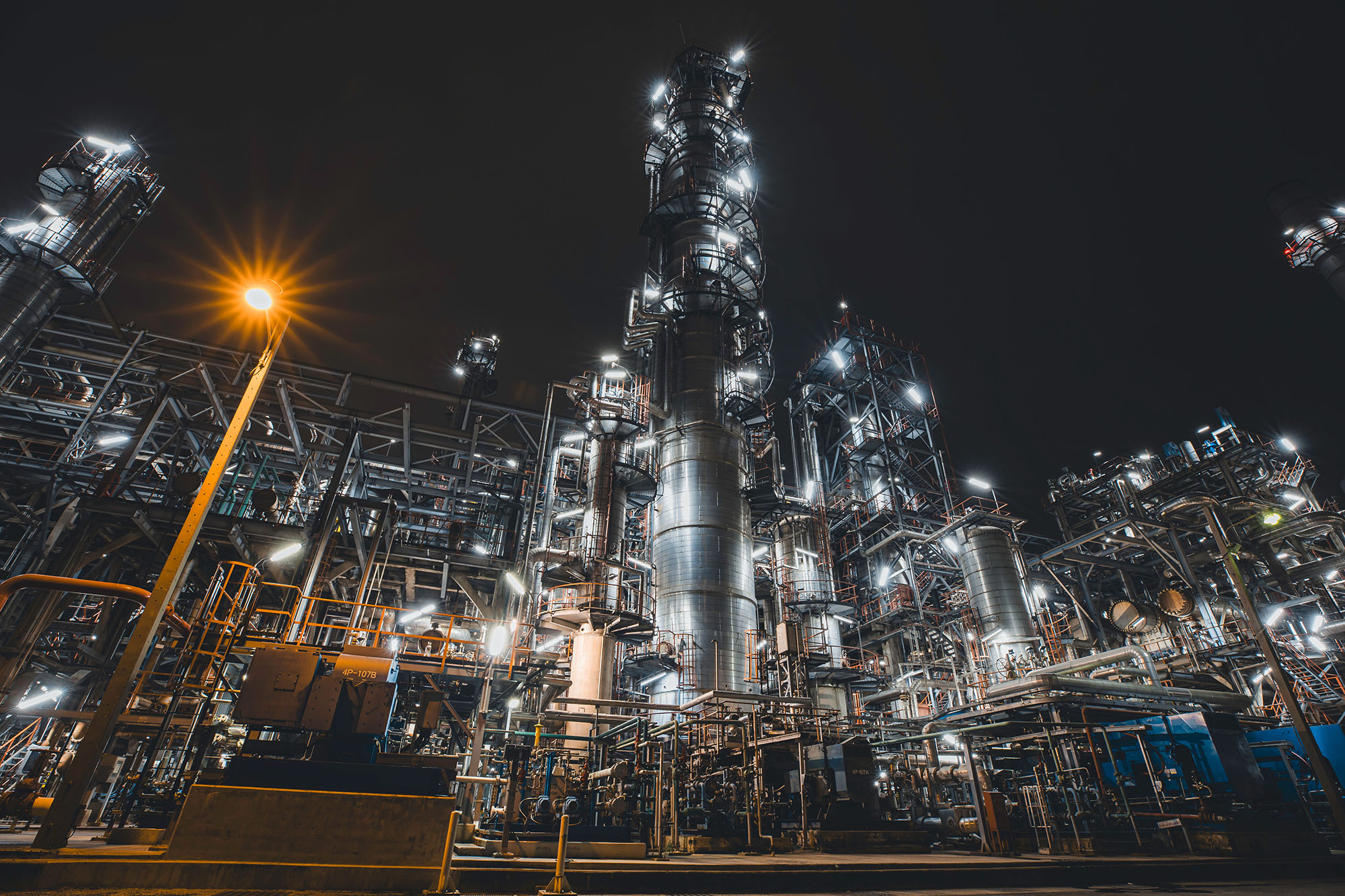 Oil refinery heavy plant from industry zone, night view tank oil